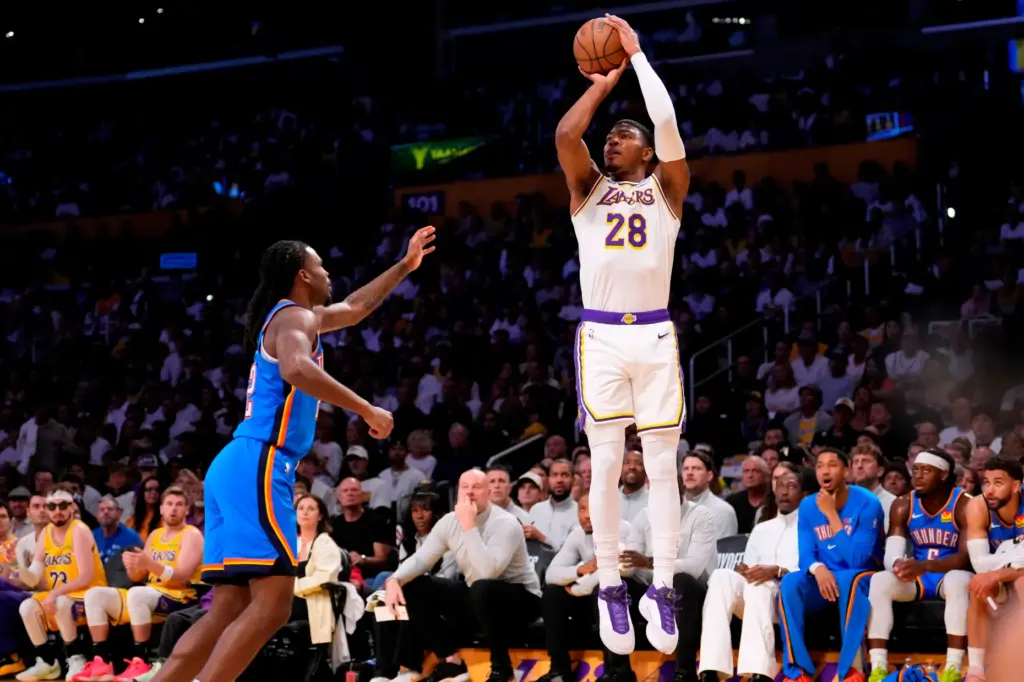Lakers forward Rui Hachimura, right, shoots as Oklahoma City Thunder...