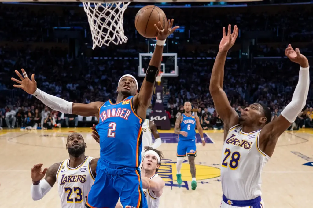 Oklahoma City Thunder star Shai Gilgeous-Alexander (2) scores in front...