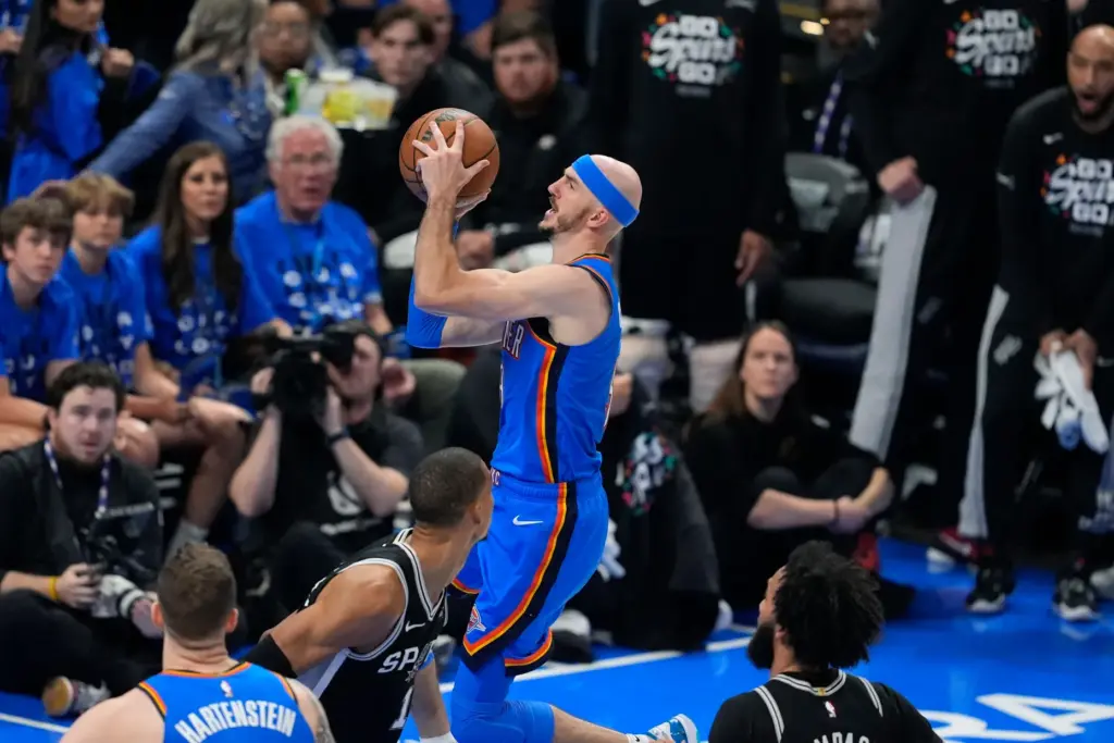 Oklahoma City Thunder guard Alex Caruso, right, drives past San...
