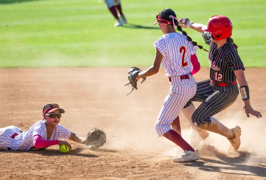 Oxnard shortstop Kayla Lorona, left, dives to field the ball,...