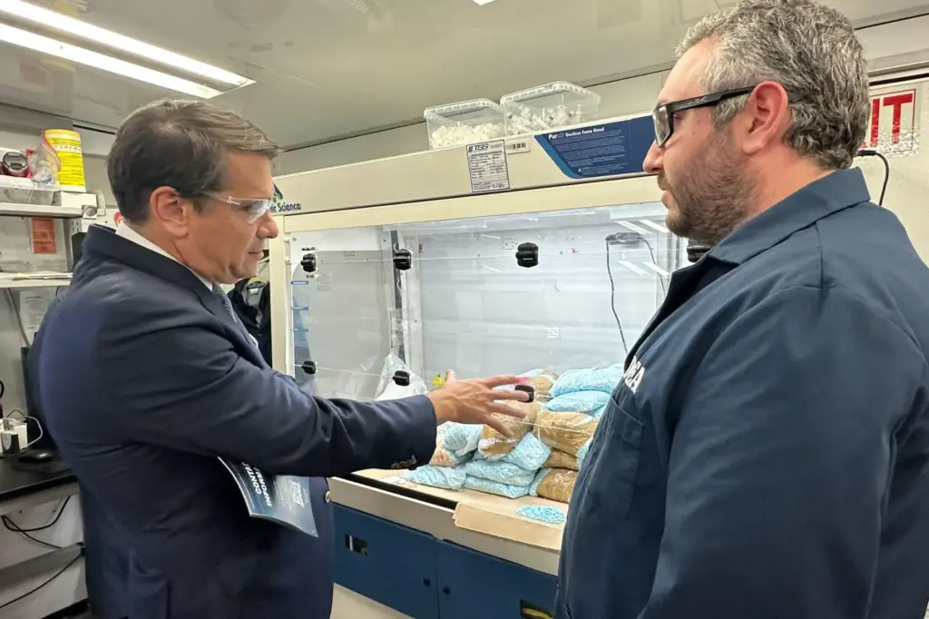 Acting Attorney General Todd Blanche talks to a technician in a Drug Enforcement Administration mobile lab.
