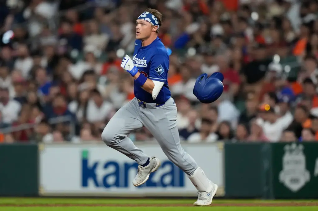 The Dodgers’ Alex Call runs to second after hitting a...