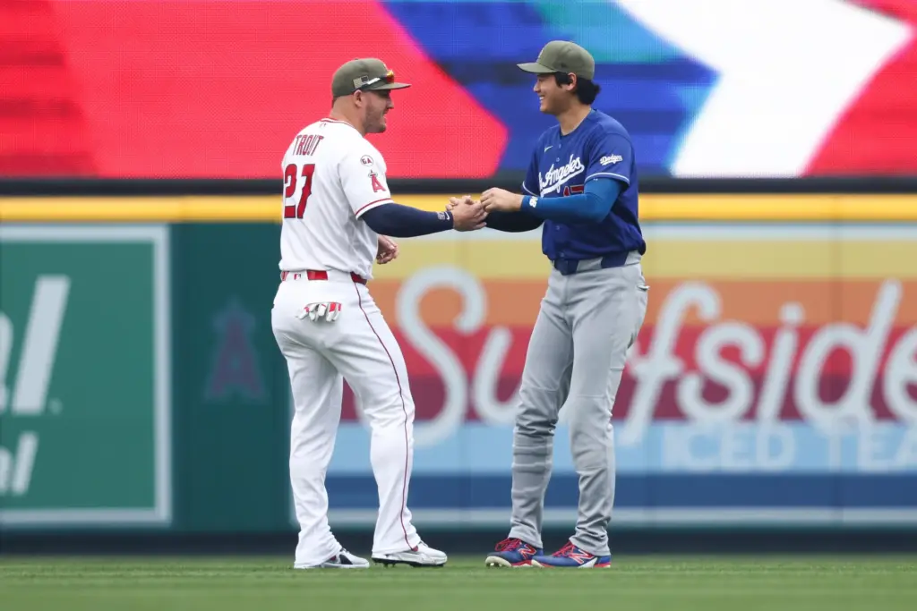 Dodgers’ Shohei Ohtani, right, and Angels’ Mike Trout, left, interact...