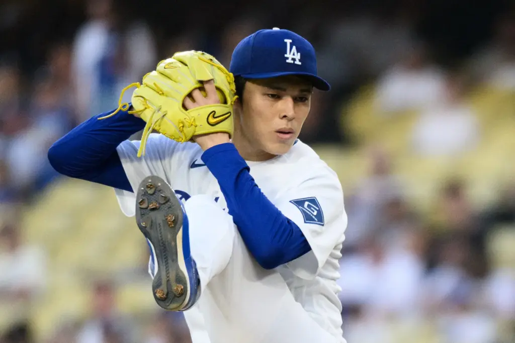 Dodgers starting pitcher Roki Sasaki throws to the plate during...