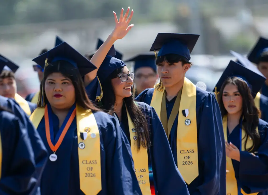 A graduate spots her family in the stands at Handel...