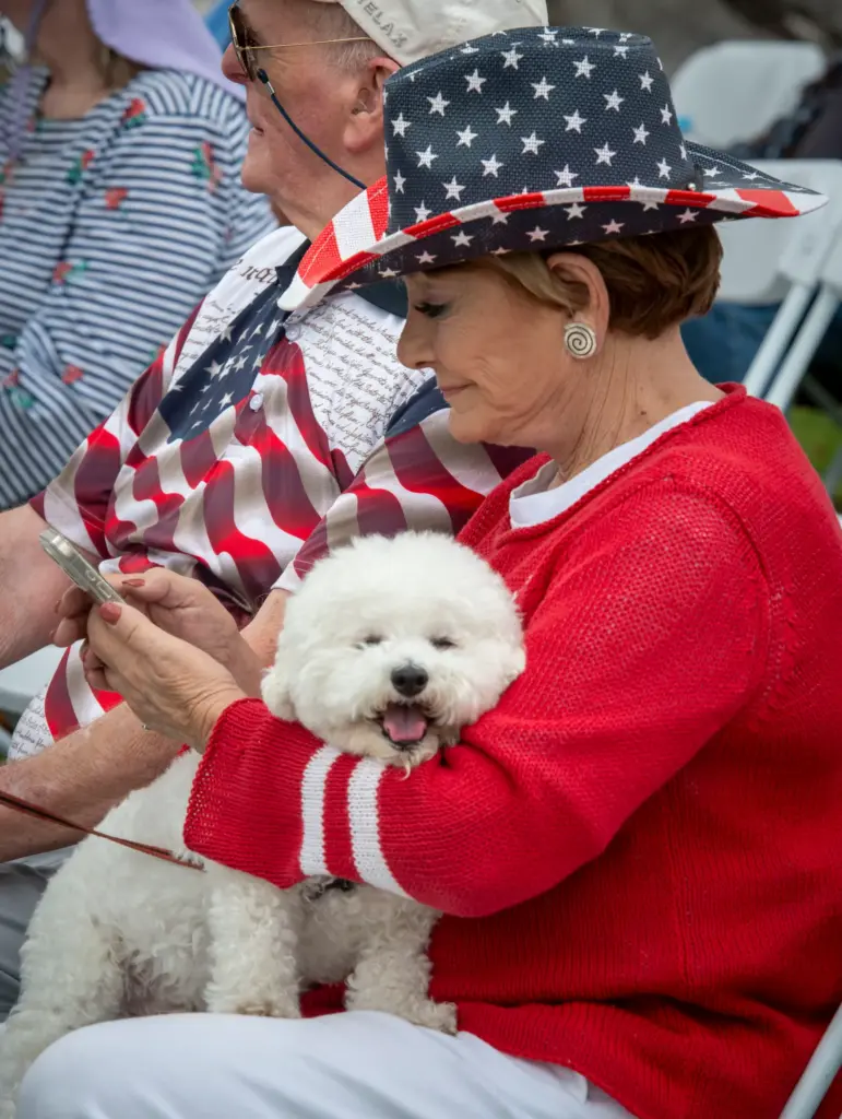 Candy Gleason with her dog Lucky during Memorial Day services...