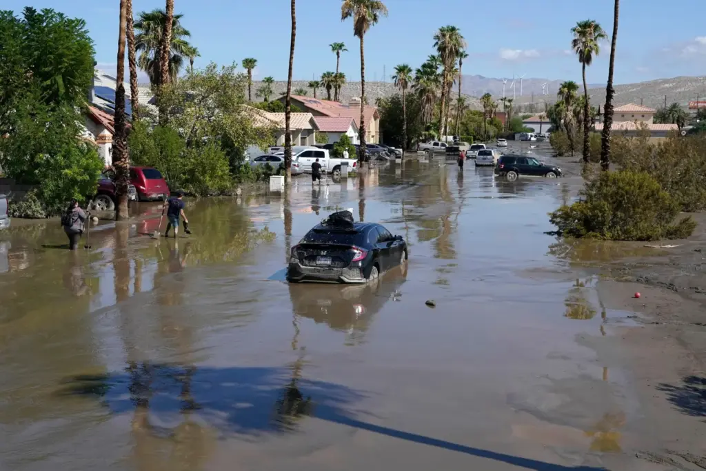 FILE – Cars are seen stuck in the mud following...
