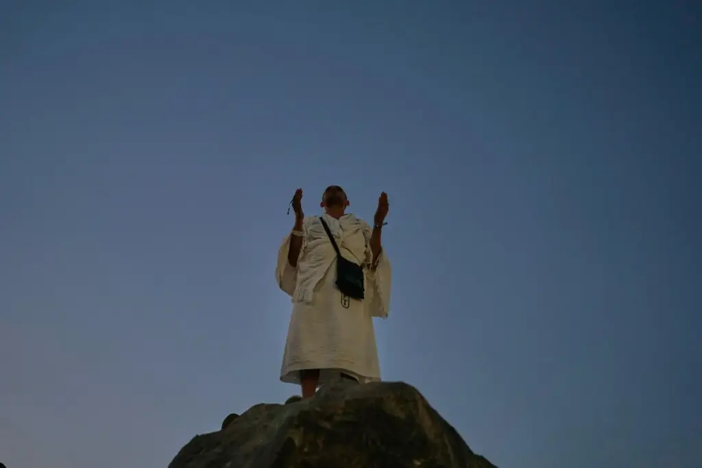 A Muslim pilgrim prays atop of the rocky hill known as the Mountain of Mercy