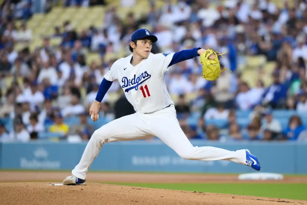 Dodgers starting pitcher Roki Sasaki throws to the plate during...