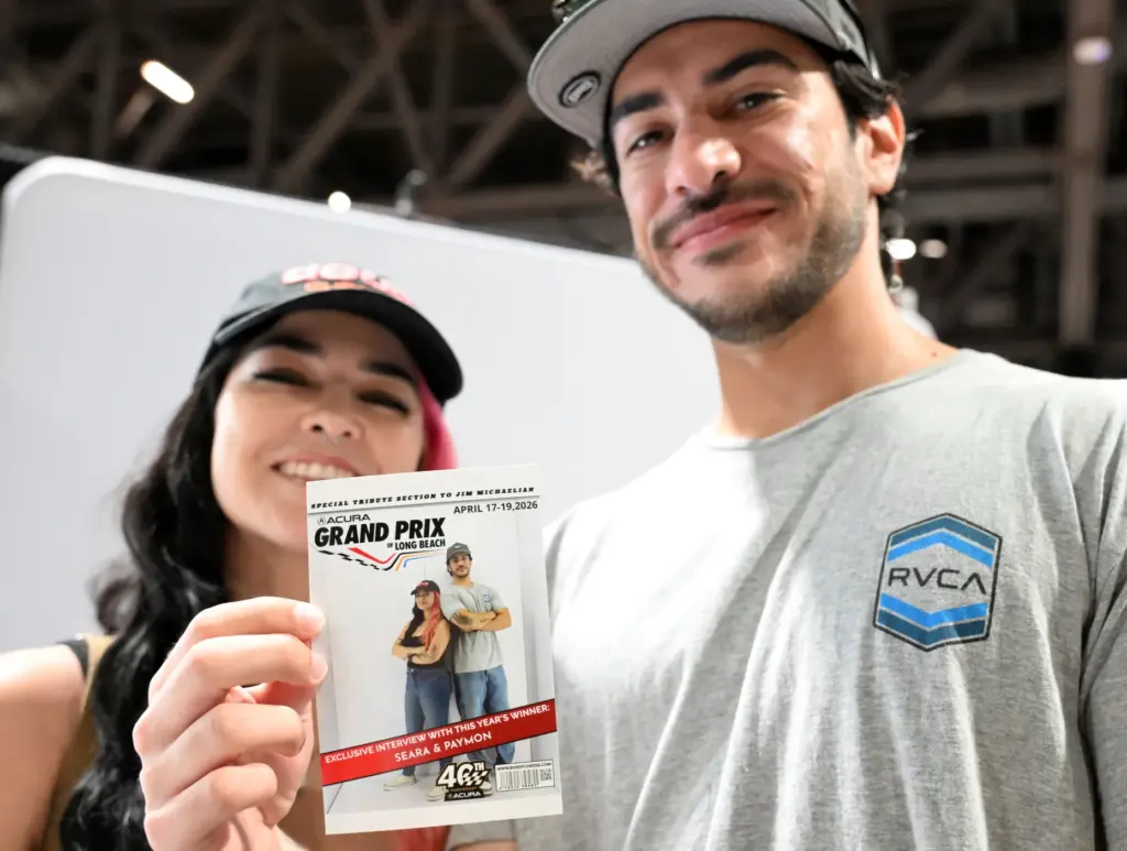 Seara and Paymon pose with their courtesy Grand Prix magazine...