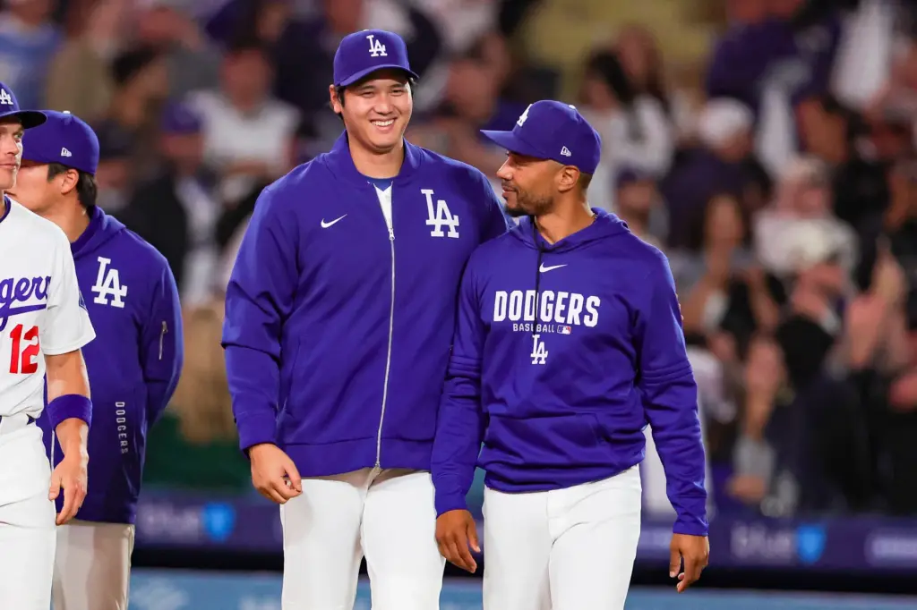 Dodgers stars Shohei Ohtani, left, and Mookie Betts smile together...