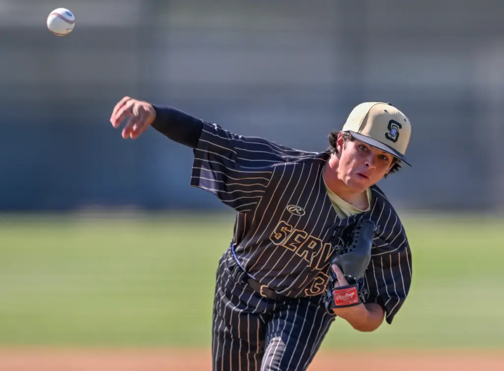 Servite starting pitcher Cole Grosthues throws to home plate during...