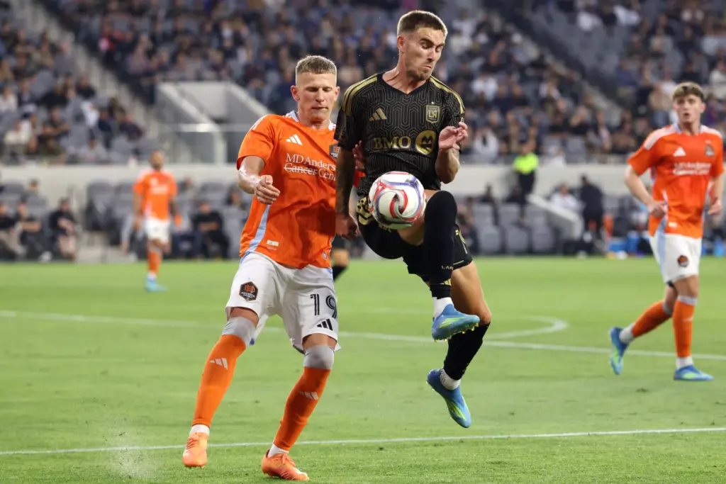 Los Angeles FC forward Tyler Boyd, front, recovers the ball...