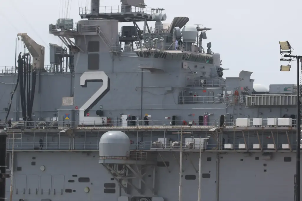 Sailors man the rails as the USS Essex arrives in...
