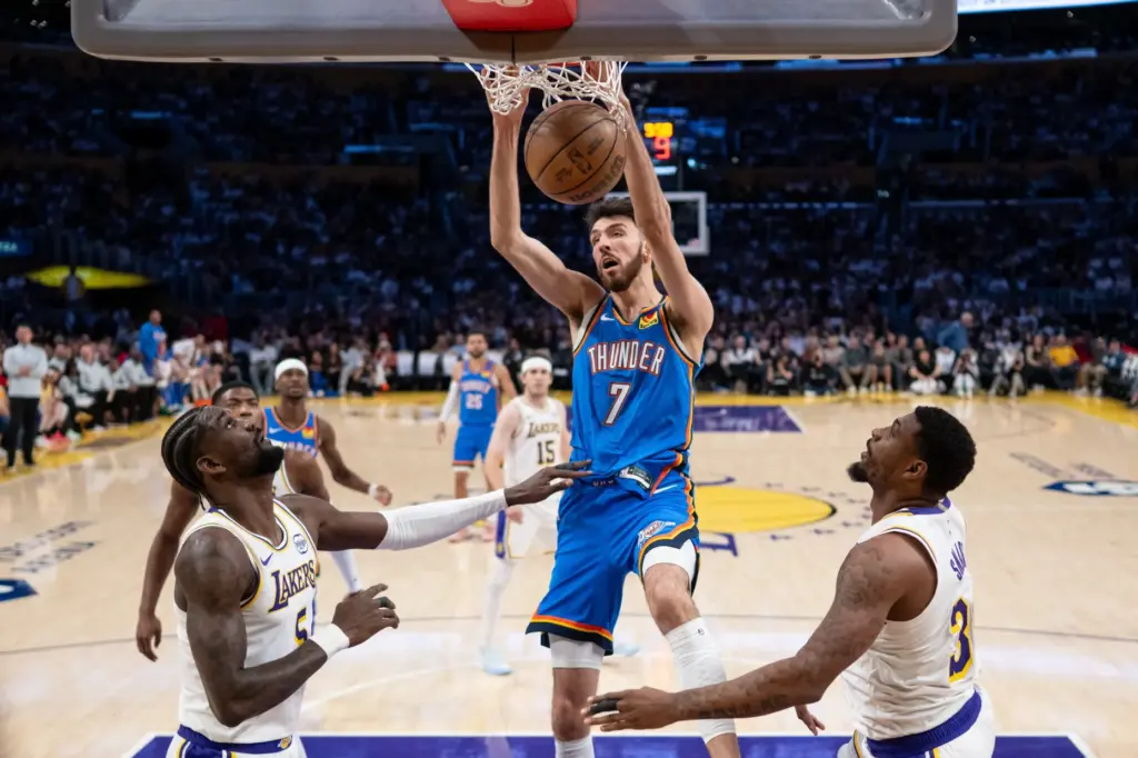 Oklahoma City Thunder forward Chet Holmgren scores in front of...