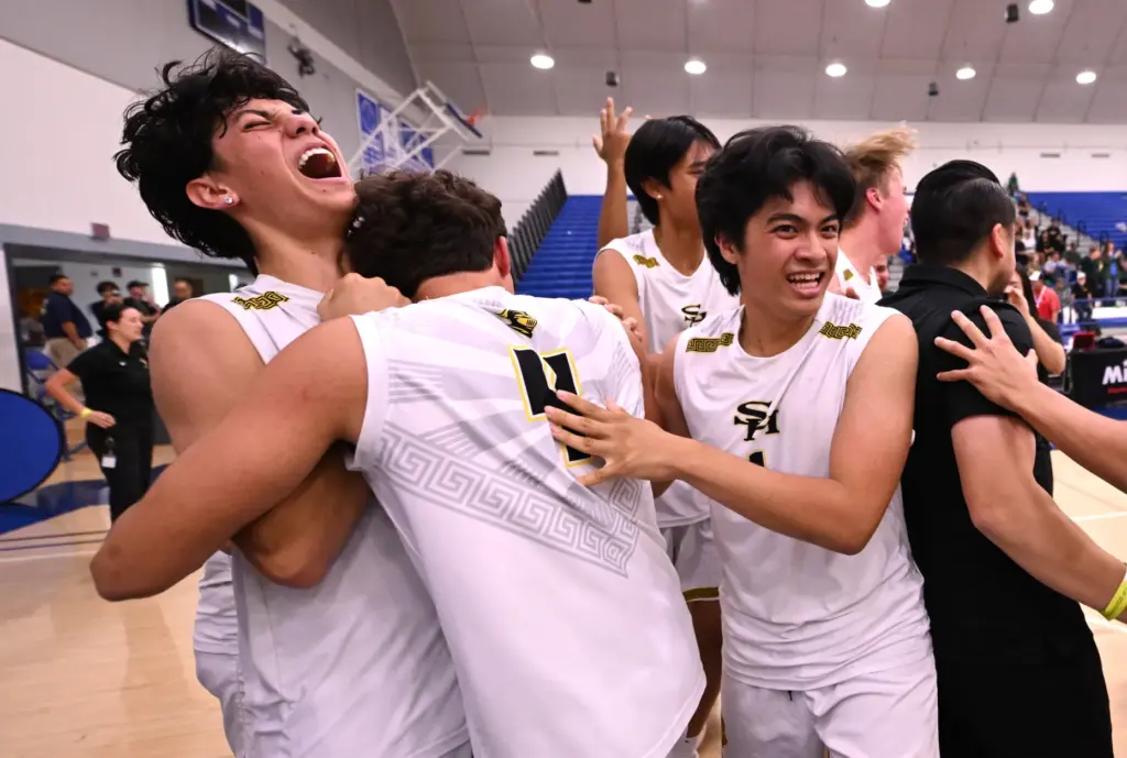Sunny Hills Lancers celebrate after defeating the Royal Highlanders to...