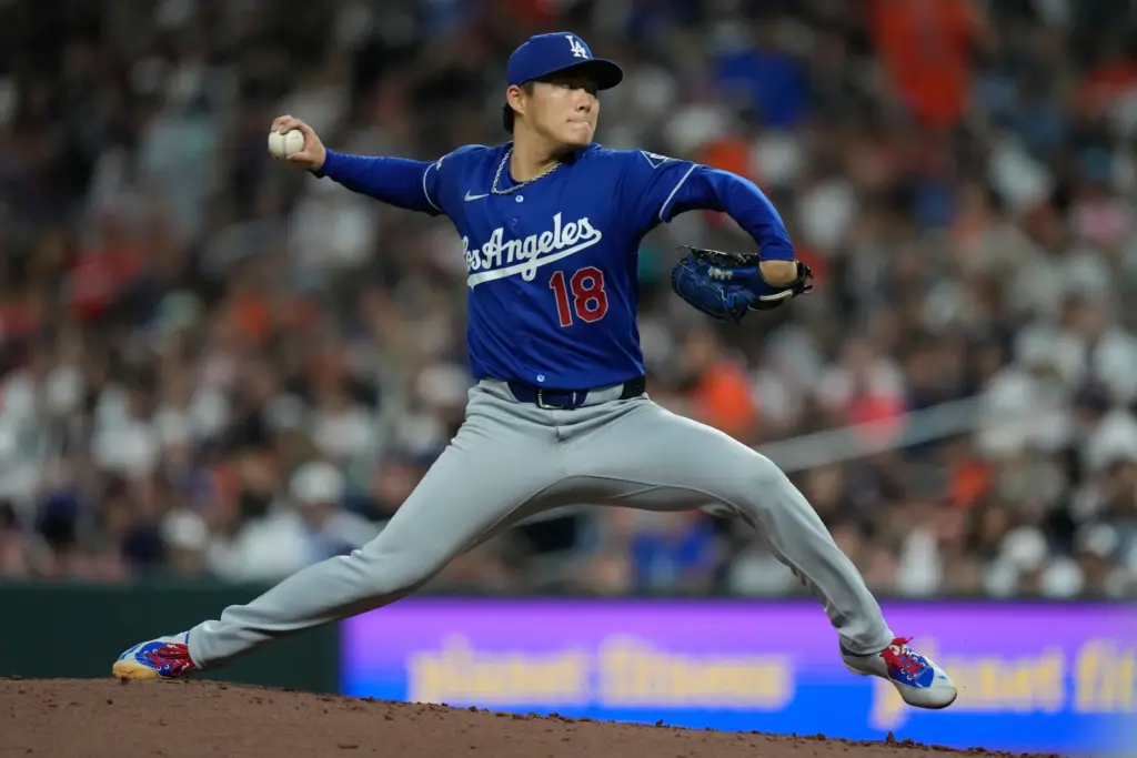 Dodgers starting pitcher Yoshinobu Yamamoto throws to the plate during...