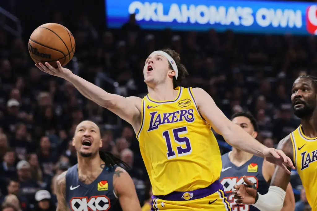 Lakers guard Austin Reaves takes a shot after getting past...