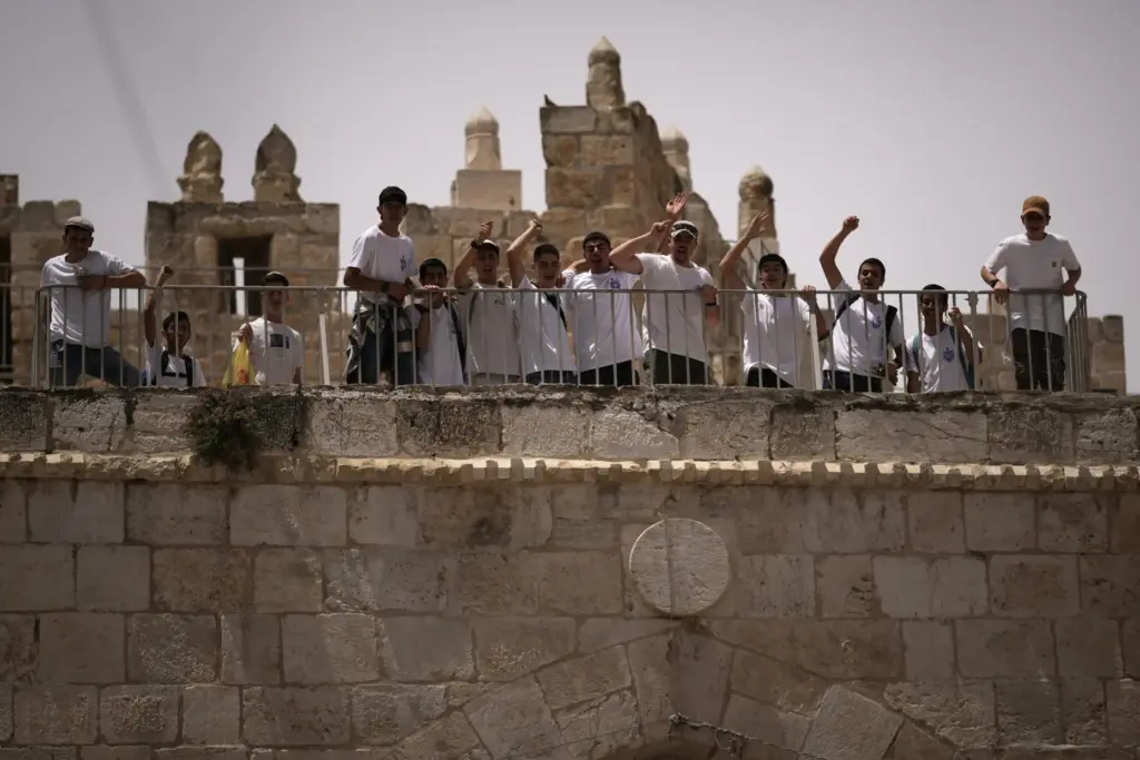 Israelis shout slogans as they gather in the Old City...