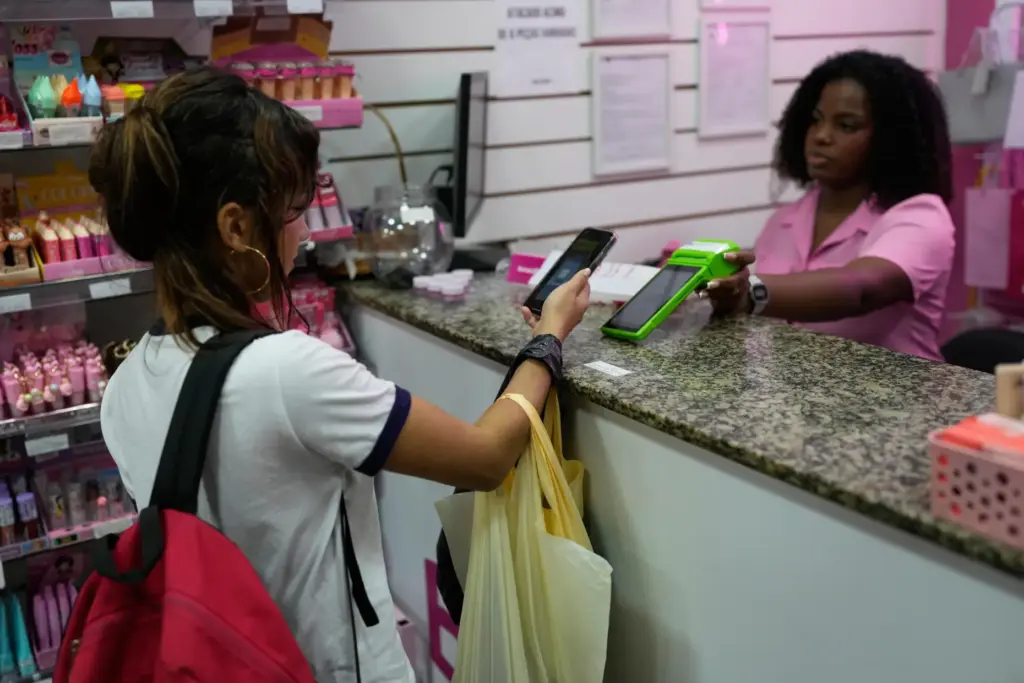 A woman pays using Pix, a free payment system, at...