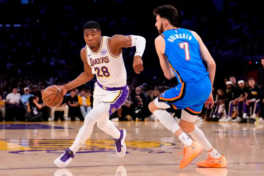 Lakers forward Rui Hachimura, left, drives as Oklahoma City Thunder...