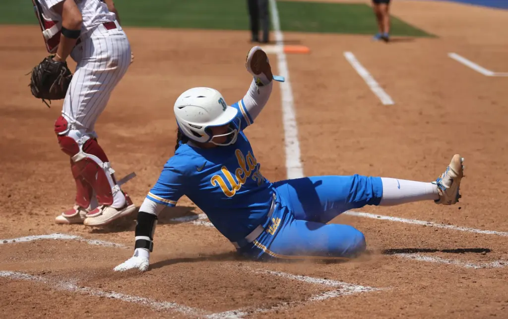 UCLAâs Alexis Ramirez slides into home to score a run...