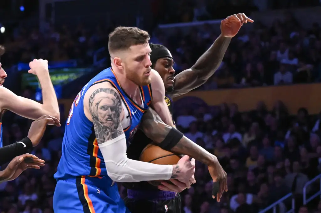Oklahoma City Thunder center Isaiah Hartenstein, left, and Lakers forward...