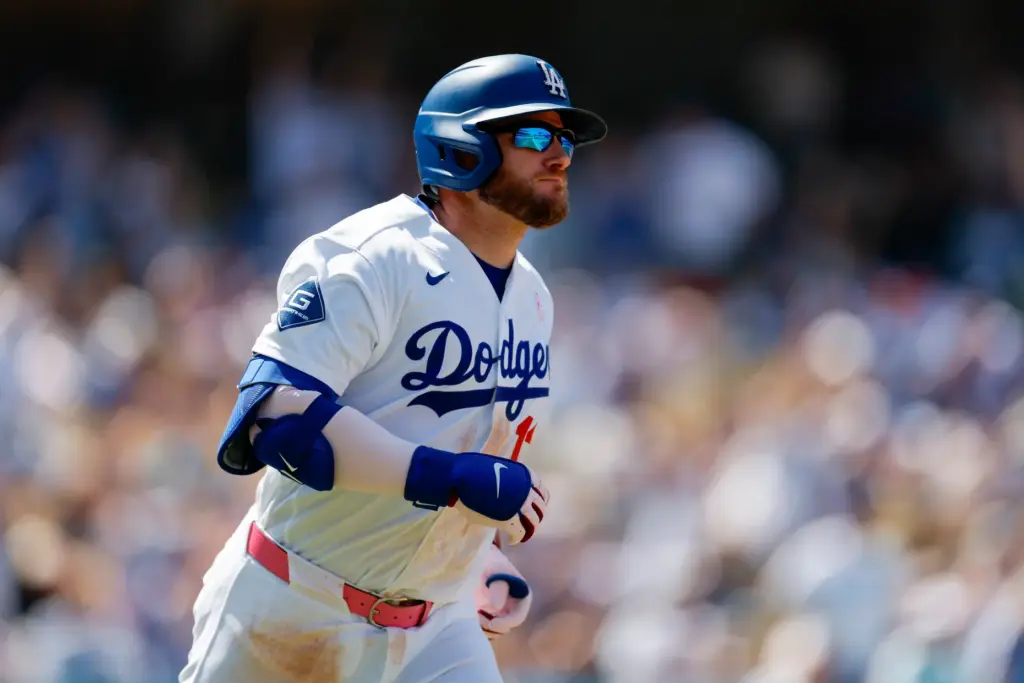 Dodgers’ Max Muncy rounds the bases after hitting a two-run...