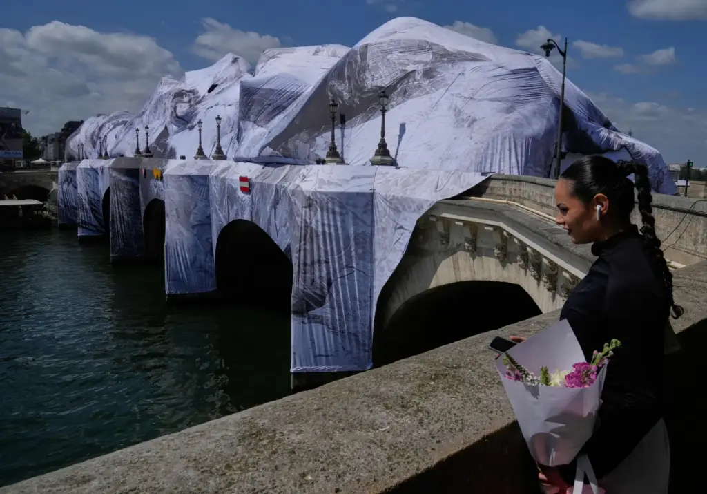 A woman looks at “The Pont Neuf Cave,” an inflated...