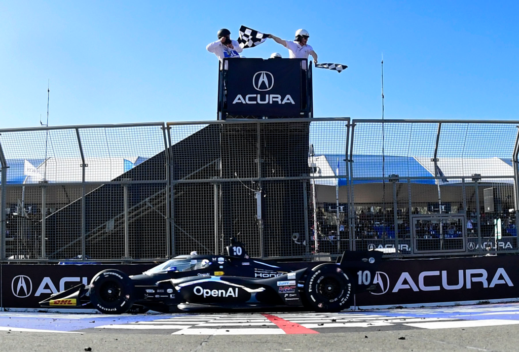 Indycar driver Alex Palou takes the checkered flag to win...