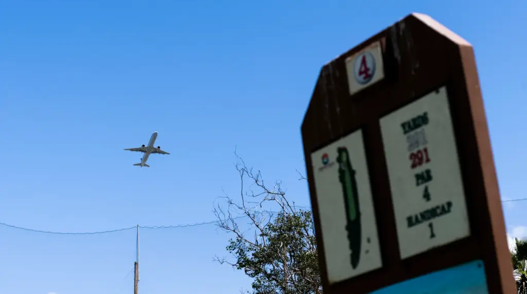 A jet from John Wayne Airport takes off over hole...