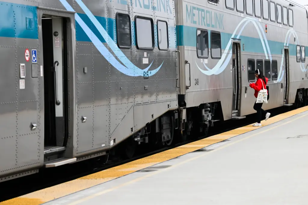 Metrolink patrons board the train during a stop in Pomona...