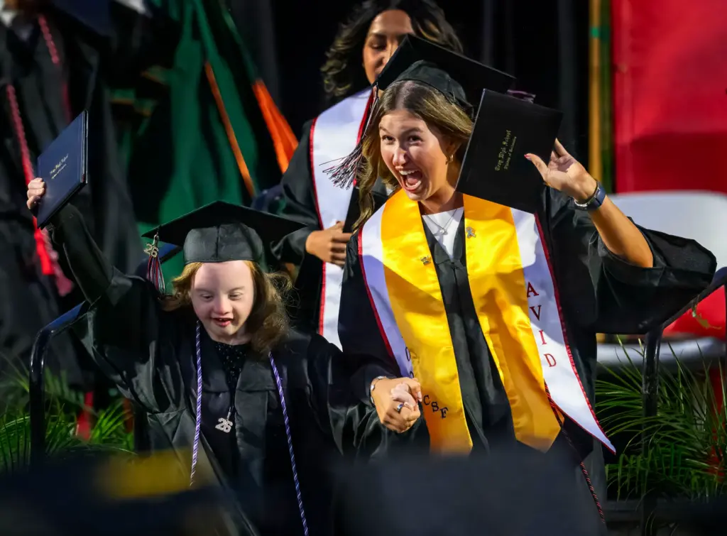 Graduates celebrate after receiving their diplomas at the Troy High...