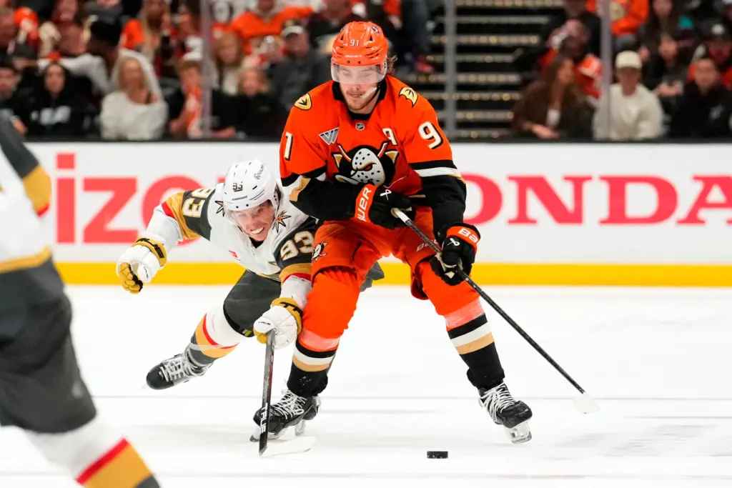 Vegas Golden Knights right wing Mitch Marner, left, reaches in...