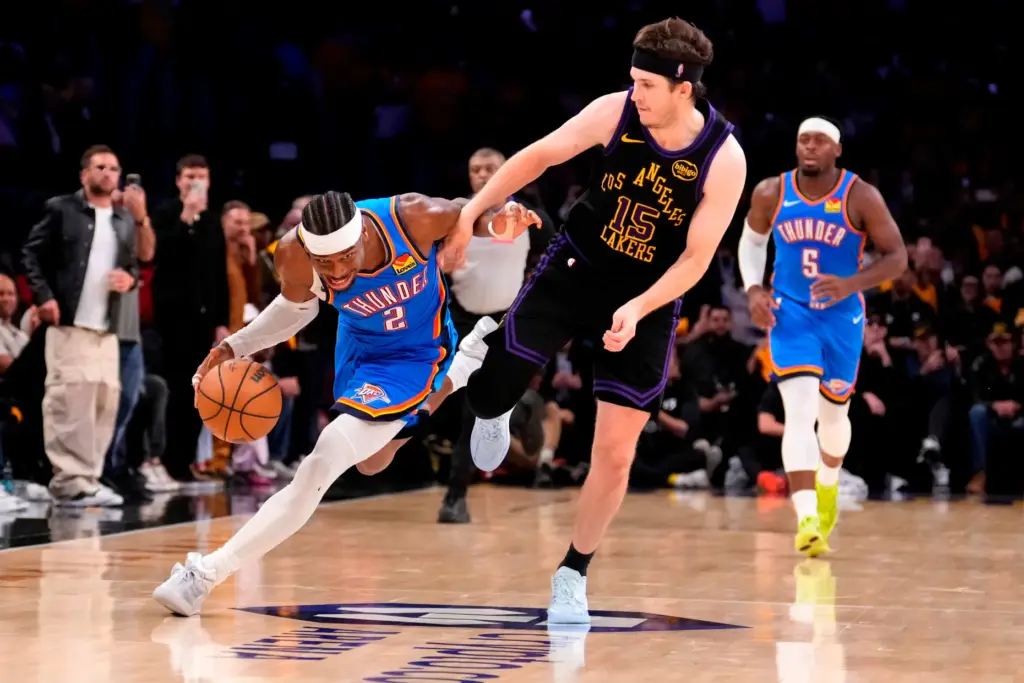 Oklahoma City Thunder guard Shai Gilgeous-Alexander, left, drives by Lakers...