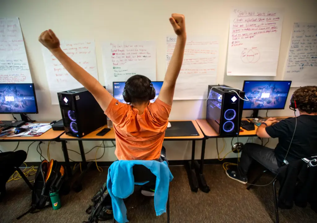 Ethan Chung of Troy High School raises his arms after...