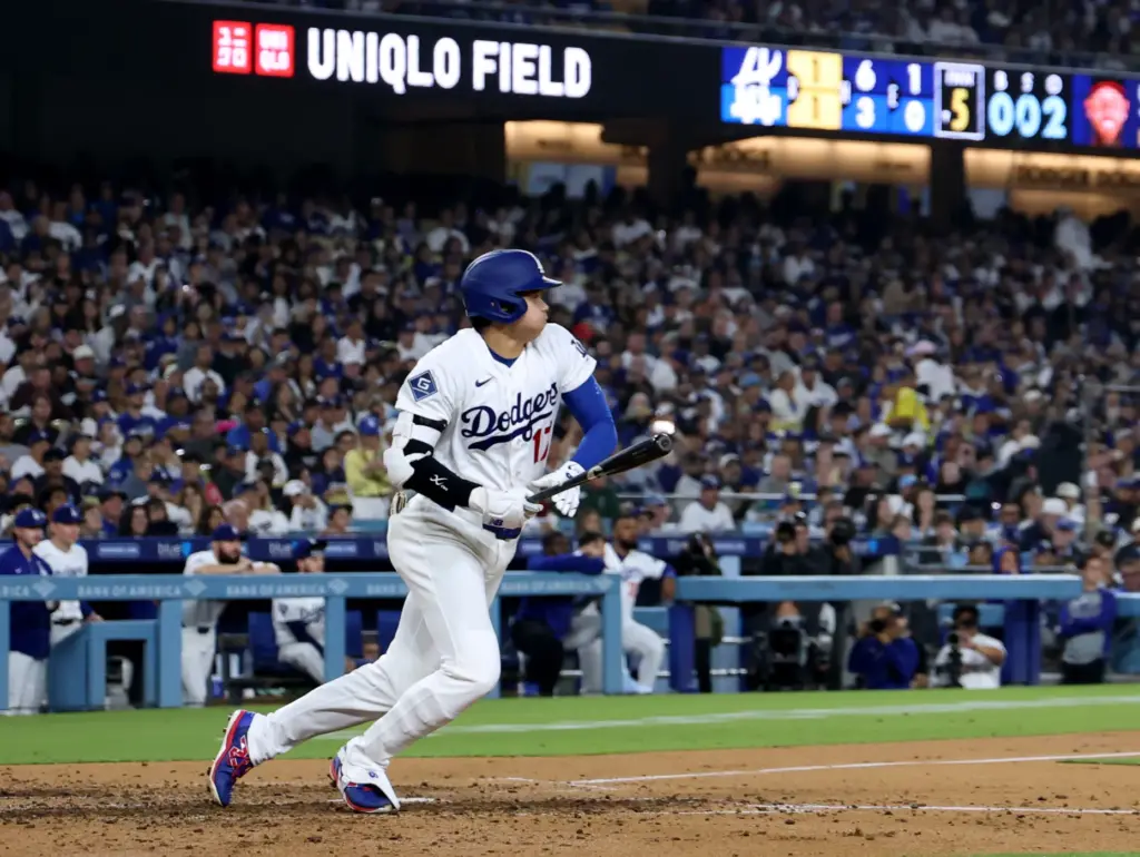 Dodgers star Shohei Ohtani begins to run after hitting an...