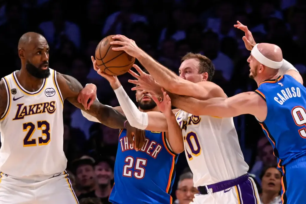 The Lakers’ LeBron James, far left, and Luke Kennard (10)...