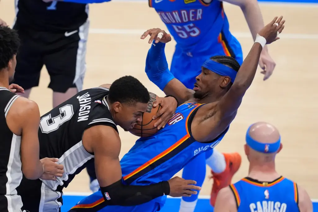 San Antonio Spurs forward Keldon Johnson (3) collides with Oklahoma...