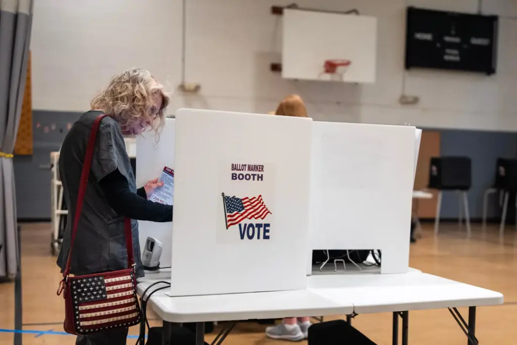 Marylou Zschach fills out her ballot at her polling place...