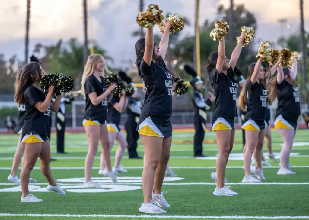 Capistrano Valley High School cheerleaders perform on the field in...