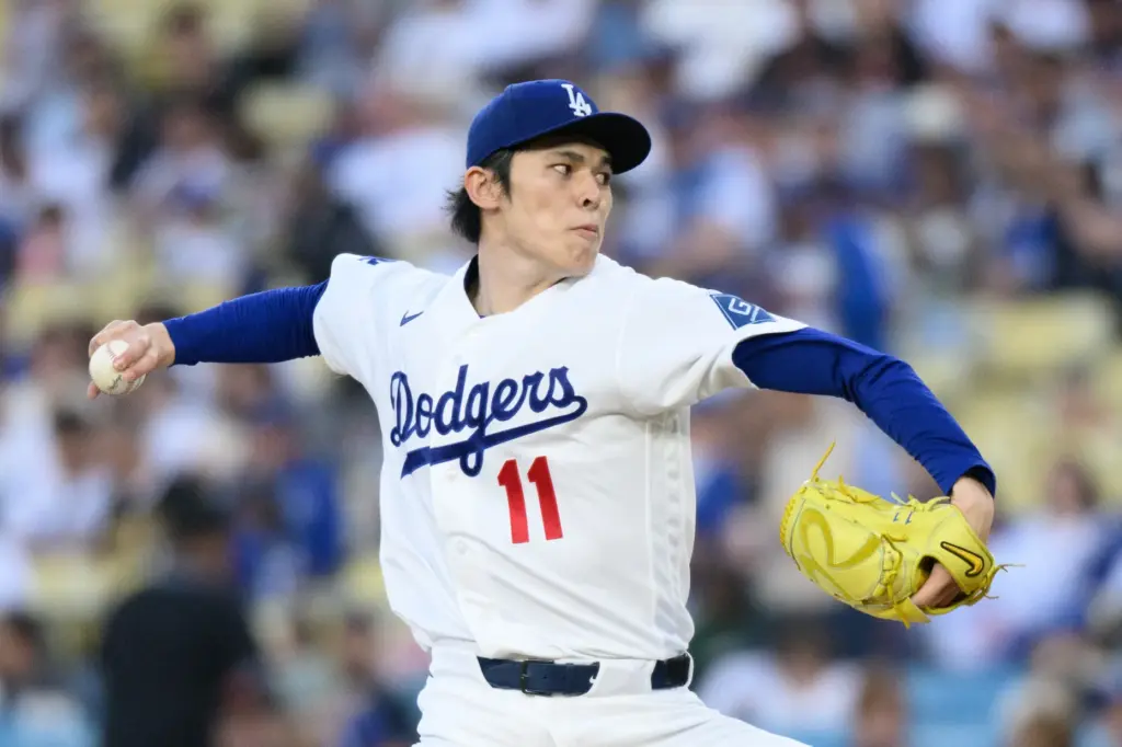 Dodgers starting pitcher Roki Sasaki throws to the plate during...