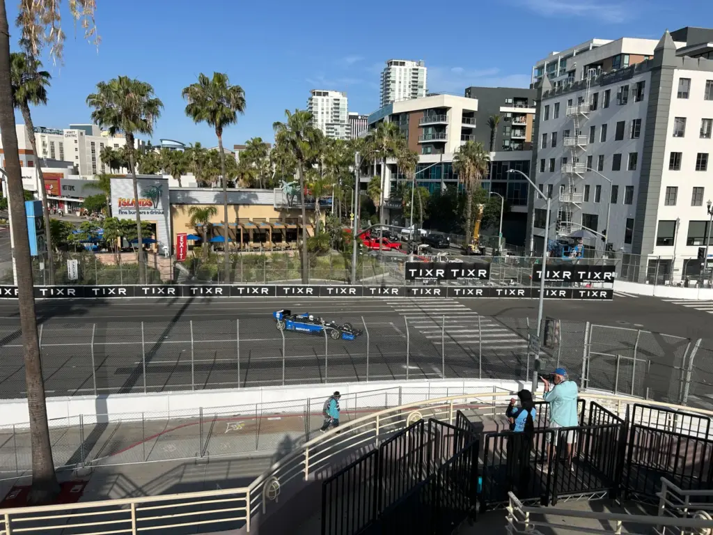 Early bird fans watch race cars zip around the 1.97-mile...
