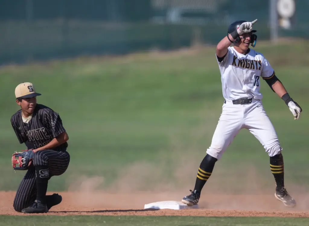 Foothillâs Aidan Gogley points to his teammates in the dugout...