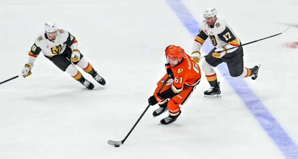 The Ducks’ Cutter Gauthier (61) controls the puck between the...