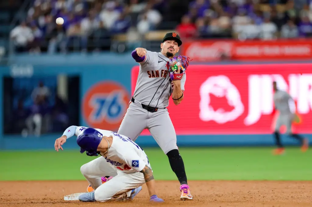 San Francisco Giants shortstop Willy Adames, right, attempts to throw...