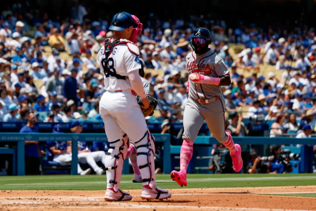 Atlanta Braves’ Michael Harris II, right, runs to score on...