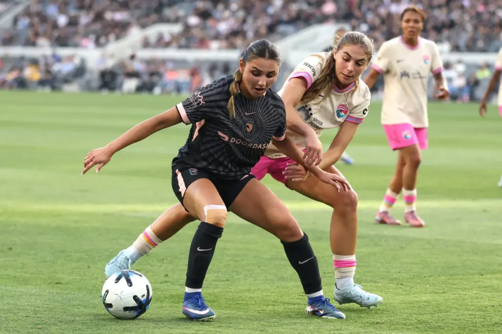 Angel City FC defender Gisele Thompson, front, controls the ball...