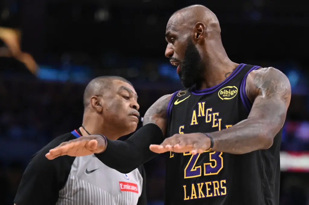 Lakers star LeBron James talks to an official about a...