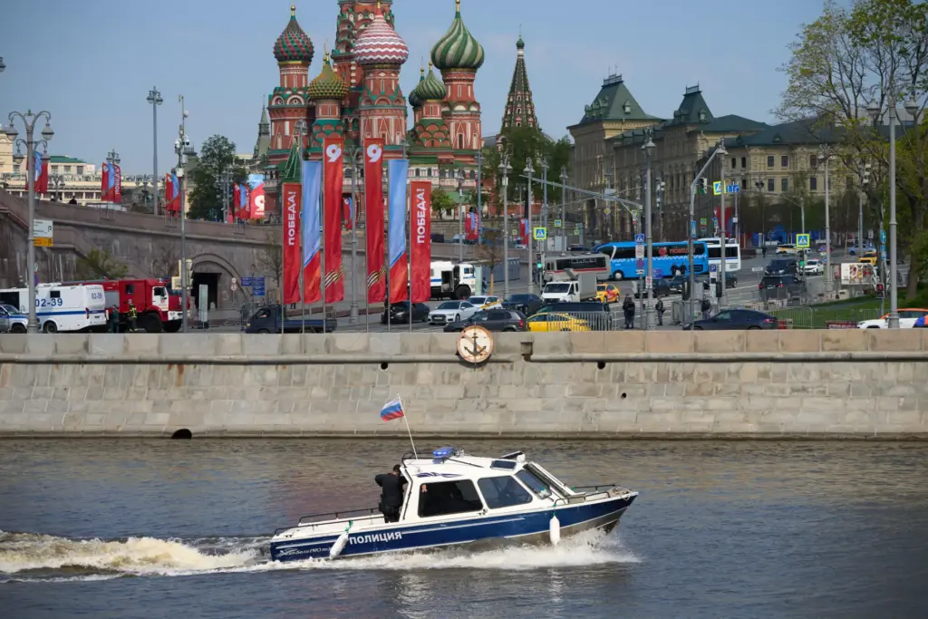 A police boat patrol the waters of the Moskva River